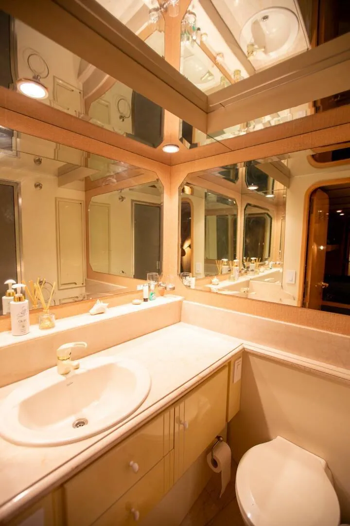 Slide: The Image of Luxurious bathroom interior of a 1999 Tarrab Motor Yacht with elegant fixtures and mirrors. - 16