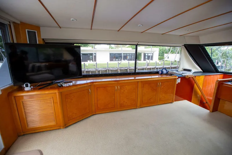 Slide: The Image of Luxurious interior of a 1999 Tarrab Motor Yacht with wood cabinetry and large windows. - 25