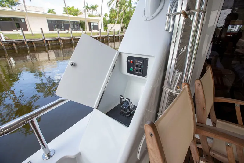 Slide: The Image of Tarrab 1999 motor yacht control panel and seating area by the water. - 32