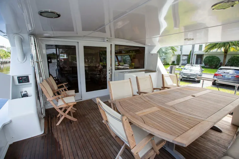Slide: The Image of Spacious deck of 1999 Tarrab Motor Yacht with wooden table and chairs. - 33