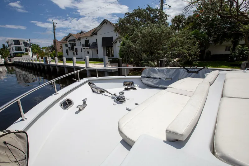 Slide: The Image of Tarrab 1999 motor yacht deck with seating, docked near waterfront homes. - 36