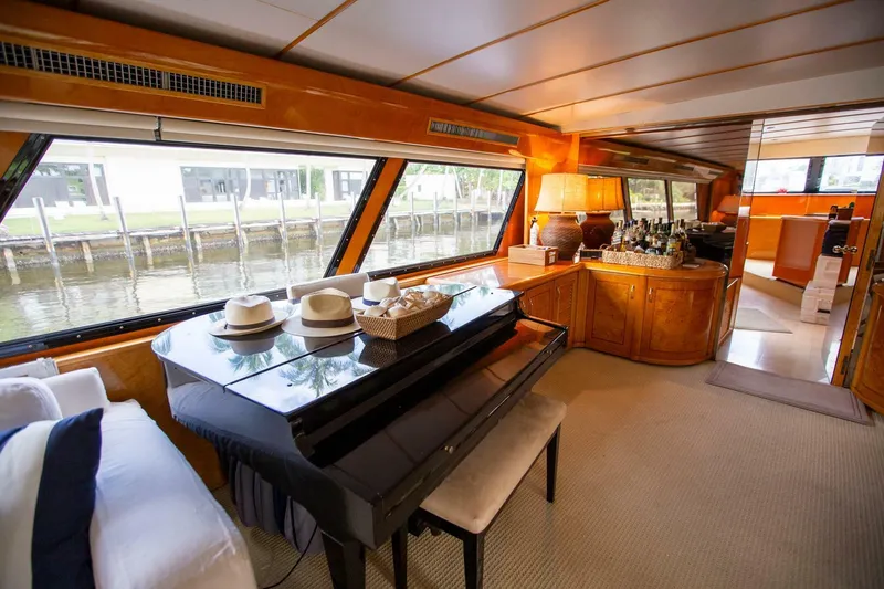 Slide: The Image of Luxurious 1999 Tarrab motor yacht interior with piano, elegant decor, and large windows. - 4
