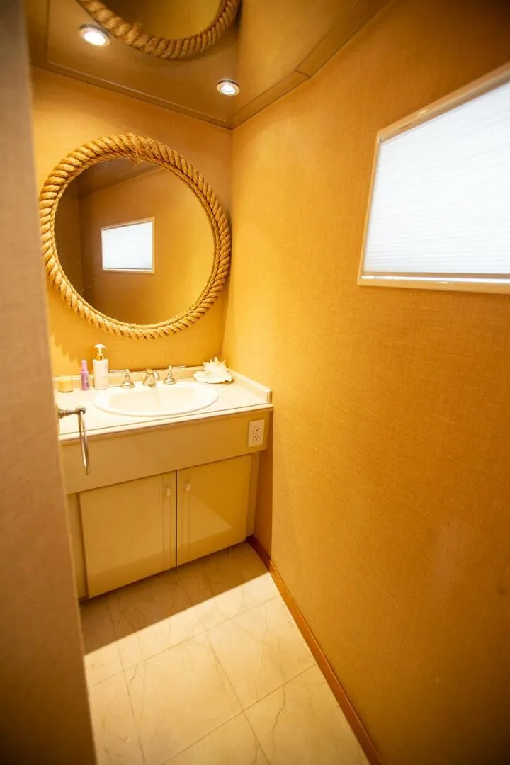 Slide: The Image of Luxurious bathroom on 1999 Tarrab Motor Yacht with elegant decor and round mirror. - 7