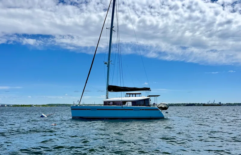 Slide: The Image of 2016 Lagoon 450S catamaran sailing on a sunny day with blue skies and calm waters. - 0