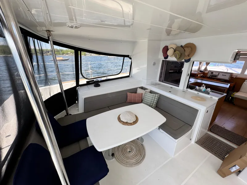 Slide: The Image of Interior of 2016 Lagoon 450S catamaran with dining area and scenic water view. - 11