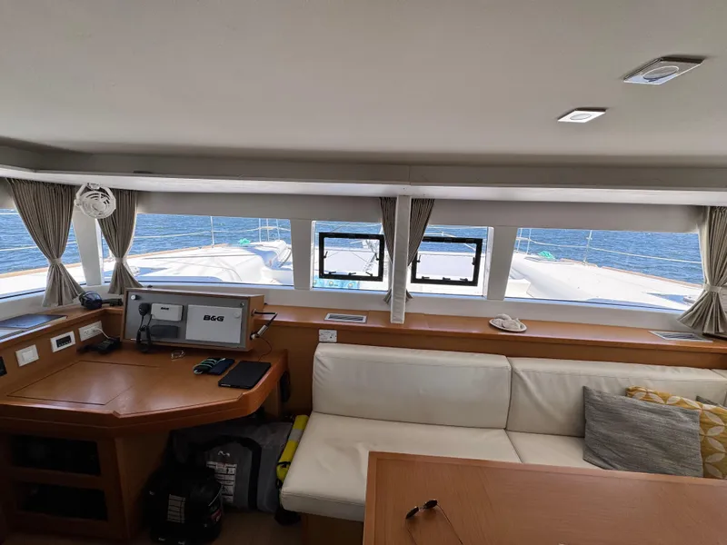 Slide: The Image of Interior of 2016 Lagoon 450S catamaran with navigation station and ocean view. - 12