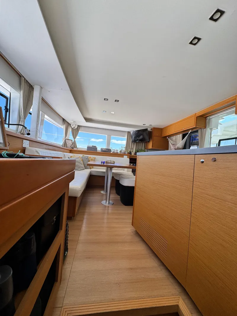 Slide: The Image of Interior of 2016 Lagoon 450S yacht with modern furnishings and panoramic windows. - 15
