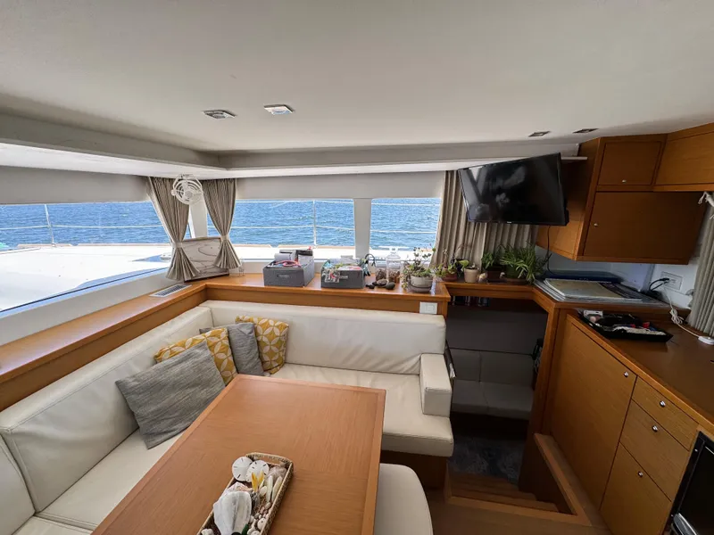 Slide: The Image of Interior of 2016 Lagoon 450S yacht with cozy seating, table, and ocean view. - 18