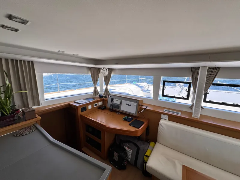 Slide: The Image of Interior of 2016 Lagoon 450S yacht with navigation station and sea view. - 19