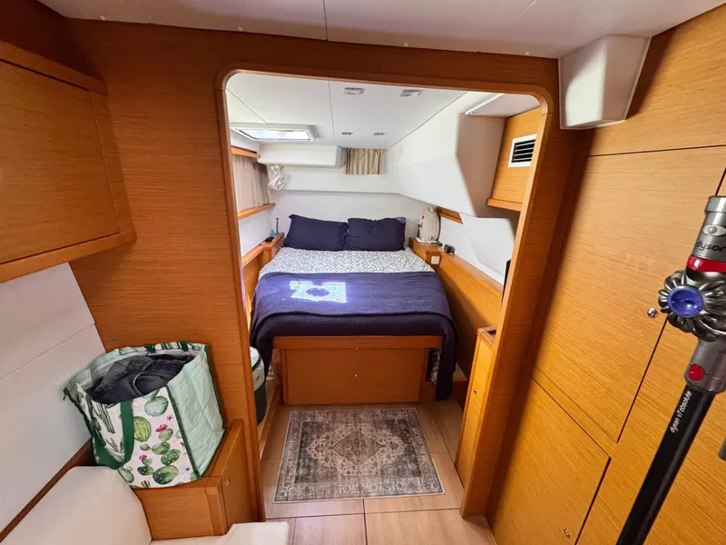 Slide: The Image of Cozy cabin interior of 2016 Lagoon 450S catamaran with bed and wooden furnishings. - 28