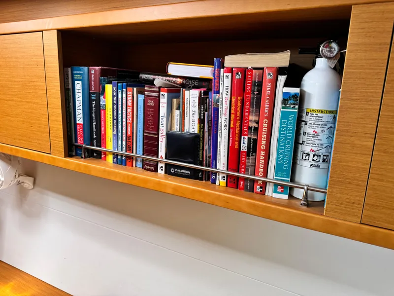 Slide: The Image of Bookshelf on Lagoon 450S yacht with sailing books and fire extinguisher, 2016 model. - 29