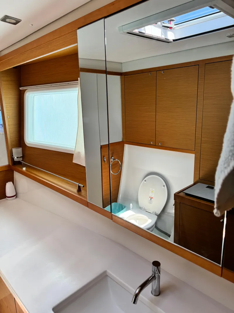 Slide: The Image of Luxurious bathroom interior of 2016 Lagoon 450S yacht with modern fixtures and wooden cabinetry. - 34