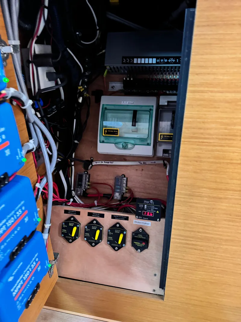 Slide: The Image of Electrical panel inside a 2016 Lagoon 450S yacht, featuring switches and wiring. - 35