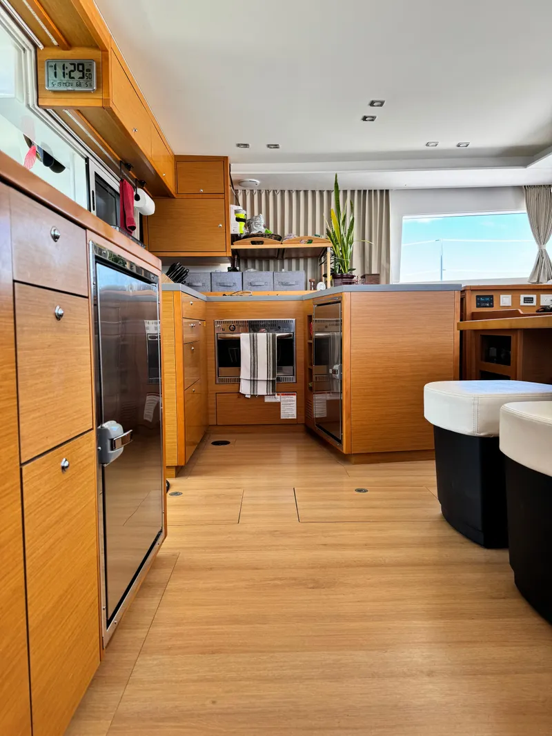 Slide: The Image of Luxurious interior of a 2016 Lagoon 450S catamaran with modern kitchen amenities. - 37