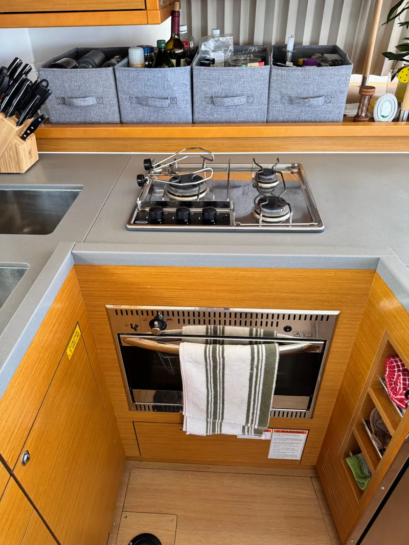 Slide: The Image of Modern kitchen in 2016 Lagoon 450S yacht with stove, oven, and organized storage. - 39