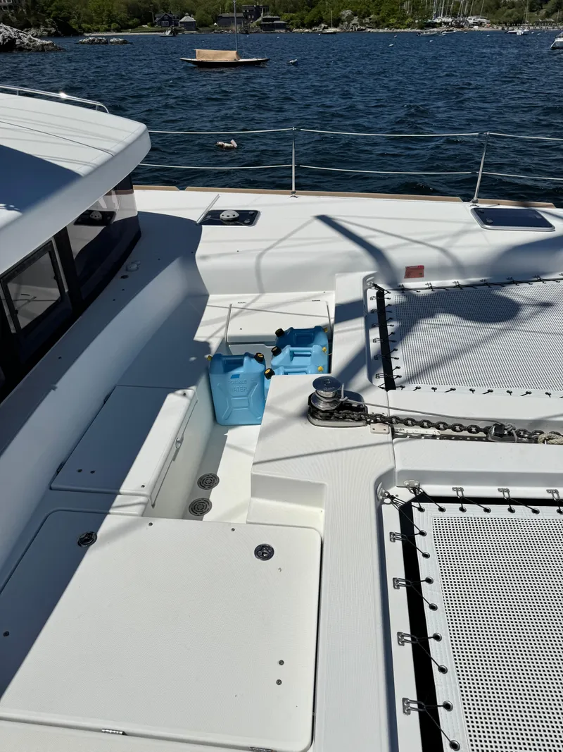 Slide: The Image of Deck of 2016 Lagoon 450S catamaran with blue containers and ocean view. - 43