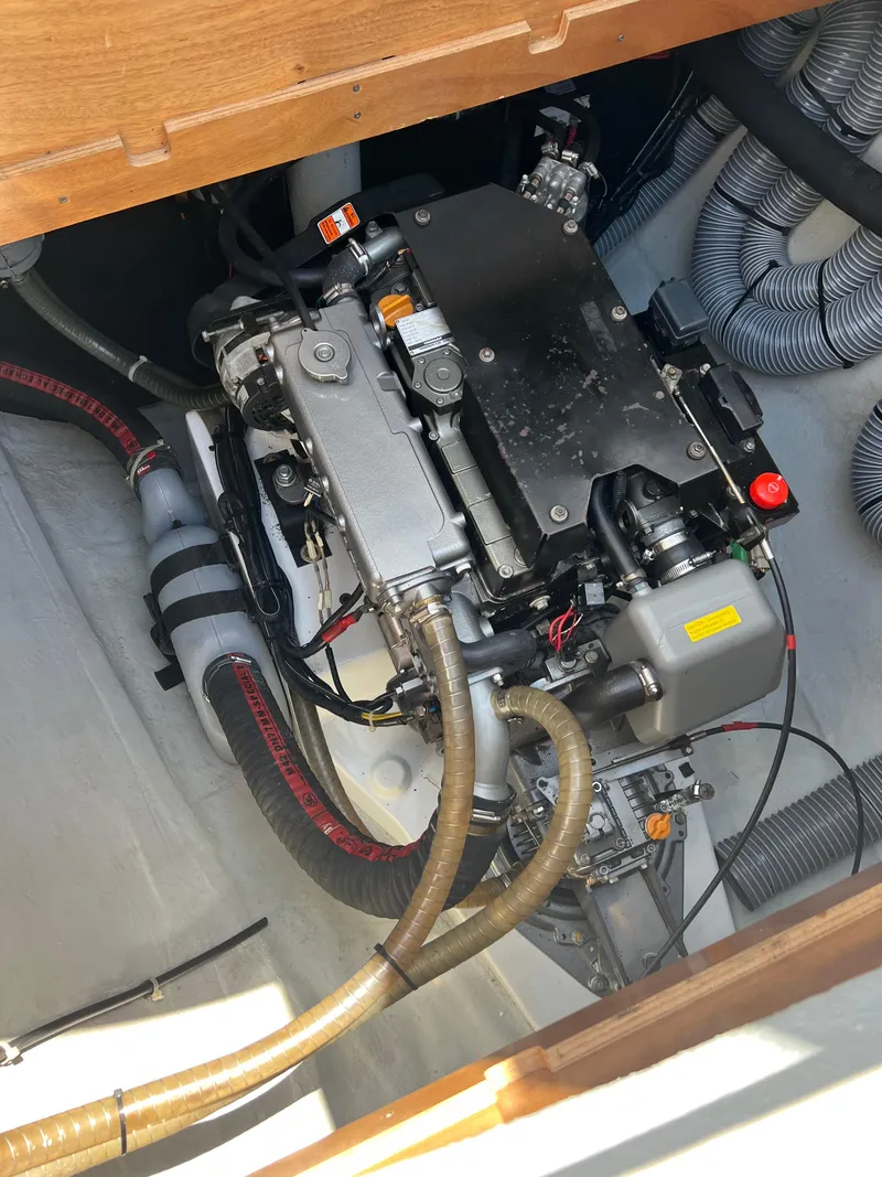Slide: The Image of Engine compartment of a 2016 Lagoon 450S yacht, showcasing mechanical components and hoses. - 48
