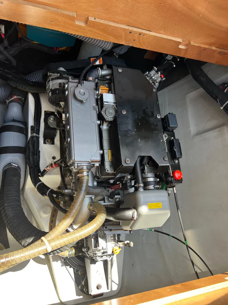 Slide: The Image of Engine compartment of a 2016 Lagoon 450S catamaran, showcasing mechanical components and hoses. - 49