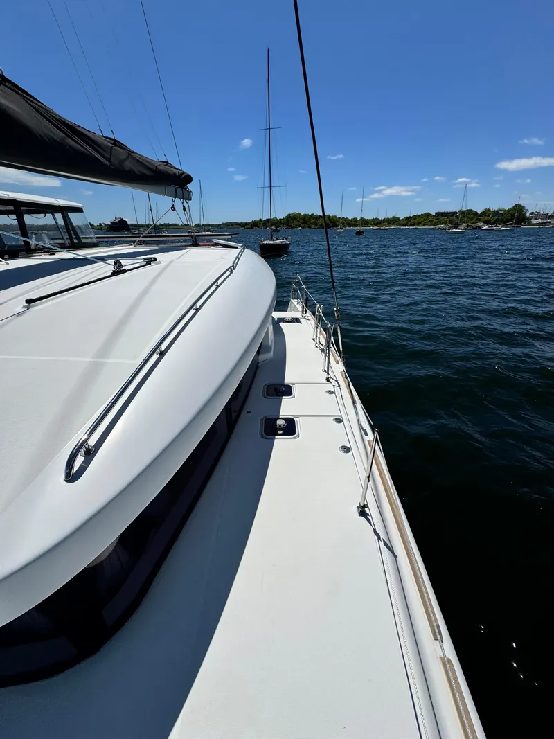 Slide: The Image of 2016 Lagoon 450S yacht on calm waters under clear blue sky. - 5