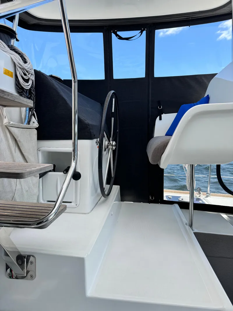 Slide: The Image of Interior view of a 2016 Lagoon 450S yacht helm with steering wheel and seating. - 7