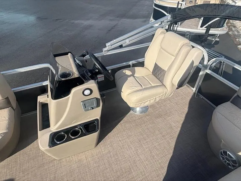 Slide: The Image of 2025 Sun Tracker PB 16 DLX boat interior with beige captain's chair and control console. - 4