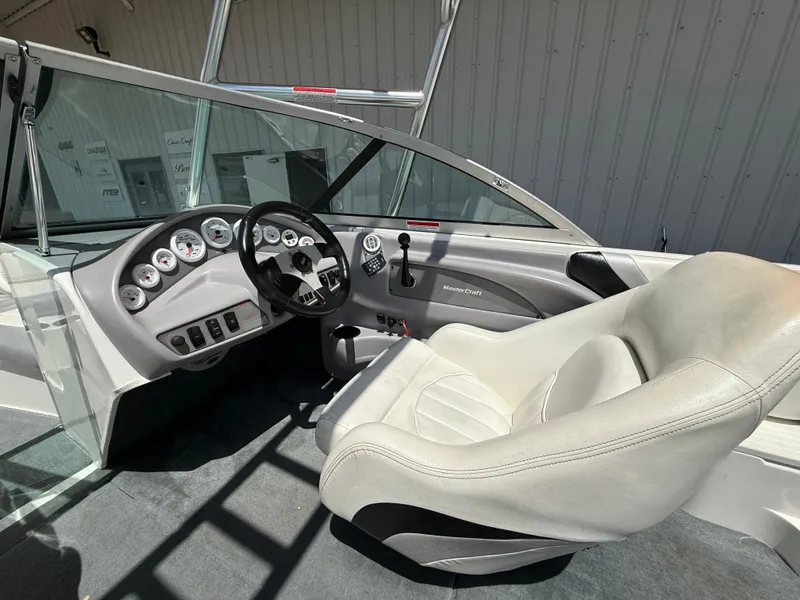 Slide: The Image of Interior of a 2000 MasterCraft XStar boat with steering wheel and dashboard controls. - 11