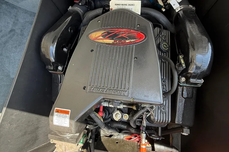 Slide: The Image of Engine of a 2000 MasterCraft XStar boat, showcasing detailed components and branding. - 17