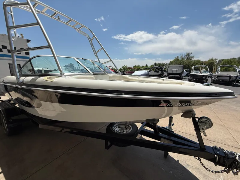 Slide: The Image of 2000 MasterCraft XStar boat on trailer under clear sky. - 4