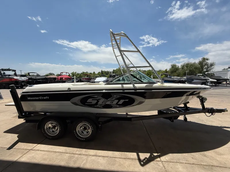 Slide: The Image of 2000 MasterCraft XStar boat on trailer under clear sky. - 5