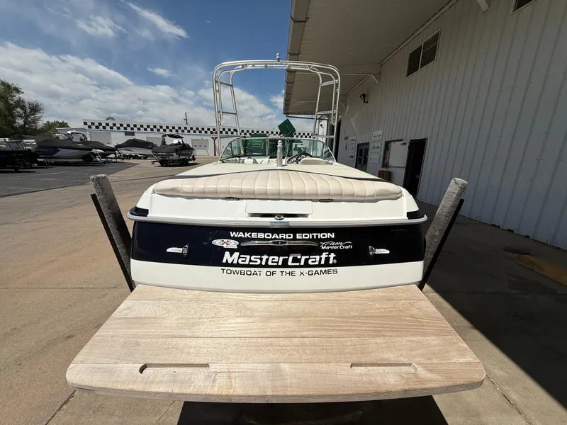 Slide: The Image of 2000 MasterCraft XStar wakeboard boat, rear view, parked outdoors. - 8