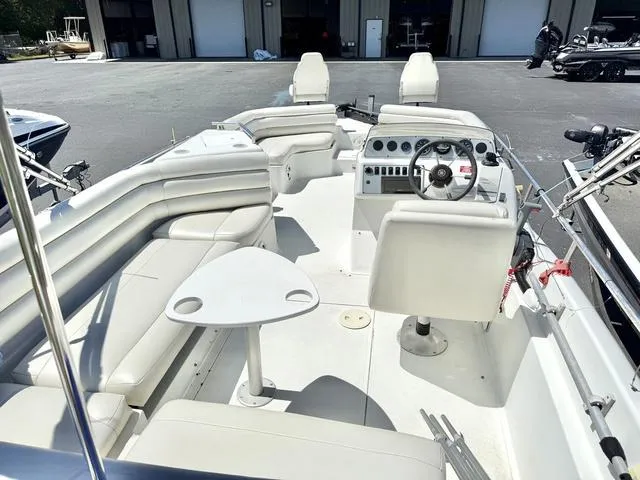 Slide: The Image of 1995 Hurricane Fundeck 230 boat interior with white seating and steering console. - 3
