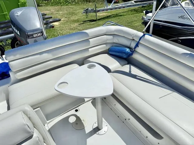 Slide: The Image of 1995 Hurricane Fundeck 230 boat interior with white seating and a small table. - 4