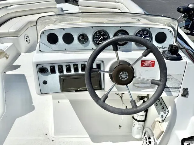 Slide: The Image of 1995 Hurricane Fundeck 230 dashboard with steering wheel and gauges. - 6