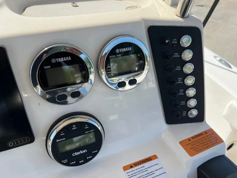 Slide: The Image of Dashboard of 2021 Robalo 226 Cayman boat with Yamaha gauges and Clarion audio controls. - 11