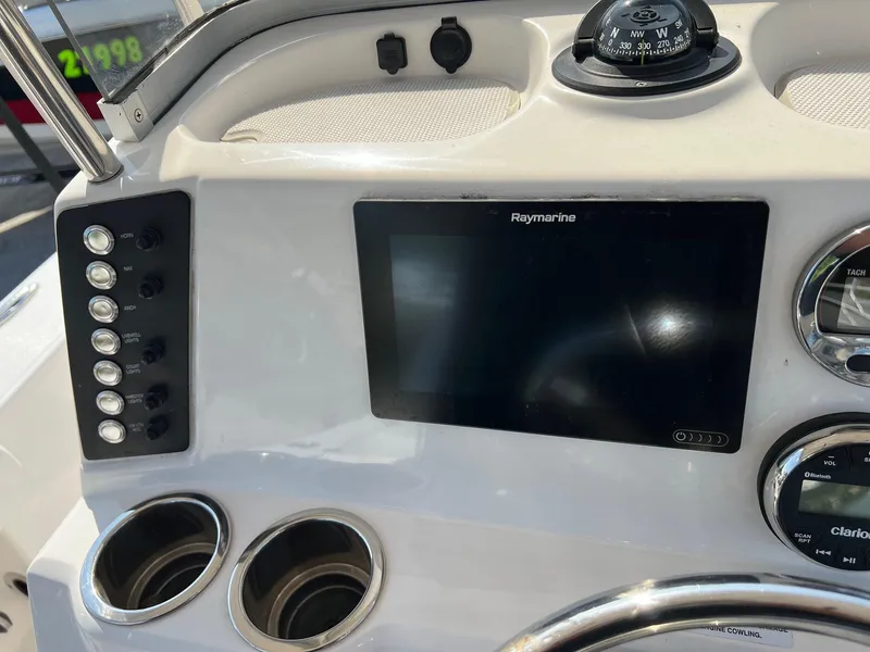 Slide: The Image of Dashboard of 2021 Robalo 226 Cayman boat with Raymarine display and compass. - 12