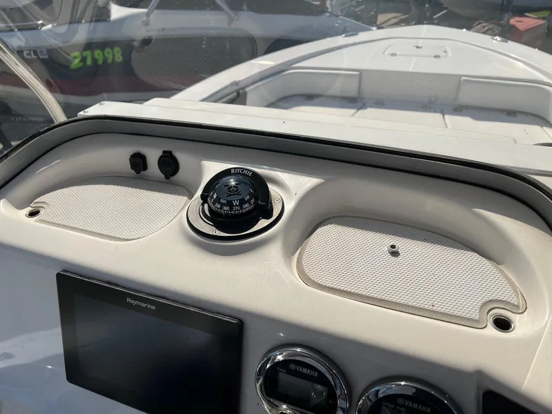 Slide: The Image of Dashboard of a 2021 Robalo 226 Cayman boat with compass and controls. - 13