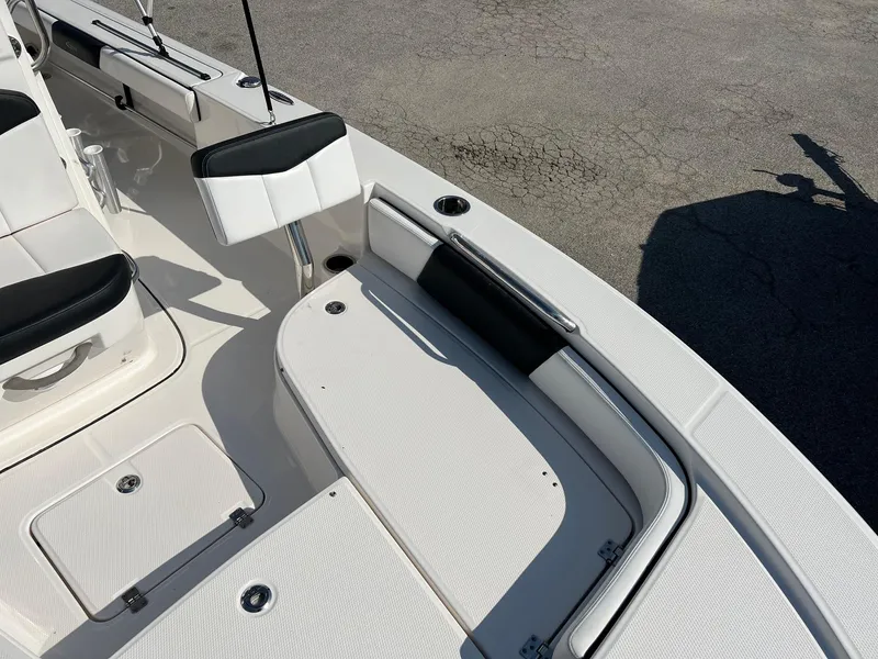 Slide: The Image of 2021 Robalo 226 Cayman boat interior with white seating and storage compartments. - 18