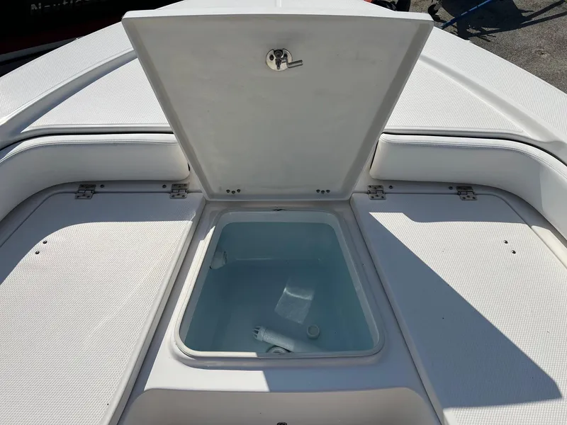 Slide: The Image of 2021 Robalo 226 Cayman boat with open storage compartment on deck. - 20