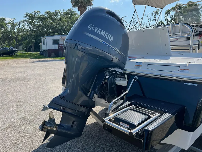 Slide: The Image of 2021 Robalo 226 Cayman with Yamaha outboard motor, parked outdoors. - 5