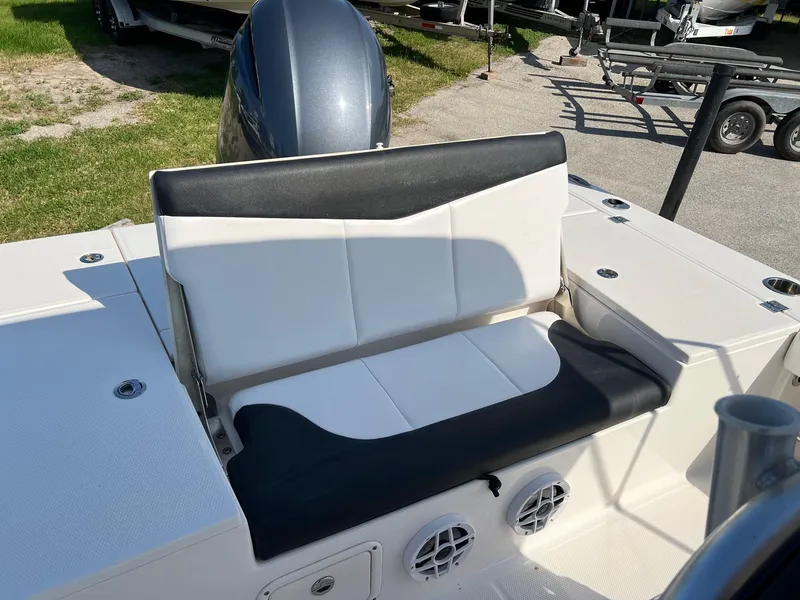 Slide: The Image of 2021 Robalo 226 Cayman boat seating area with black and white upholstery. - 6