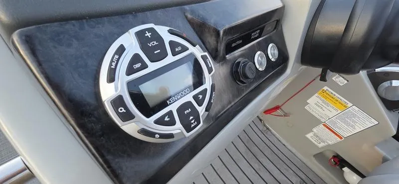 Slide: The Image of Control panel of a 2017 Regency 254 LE3 Sport boat featuring a Kenwood audio system. - 3