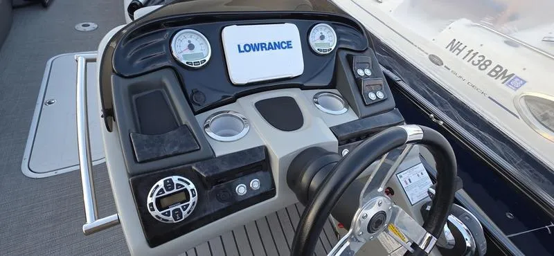 Slide: The Image of 2017 Regency 254 LE3 Sport boat dashboard with Lowrance display and steering wheel. - 8