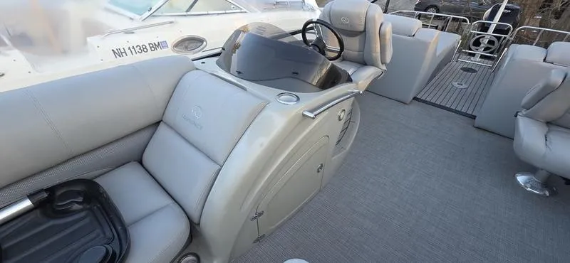 Slide: The Image of 2017 Regency 254 LE3 Sport boat interior with plush seating and steering console. - 9