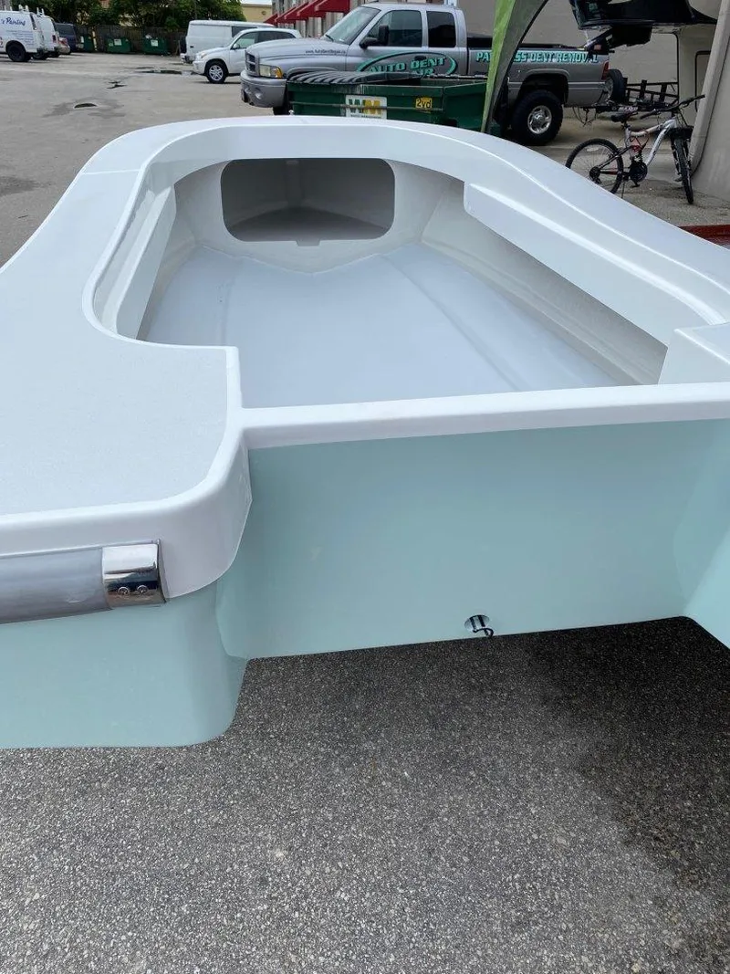 Slide: The Image of 2024 Ultra Lite Tenders ULT 300 boat, sleek design, parked outdoors. - 3