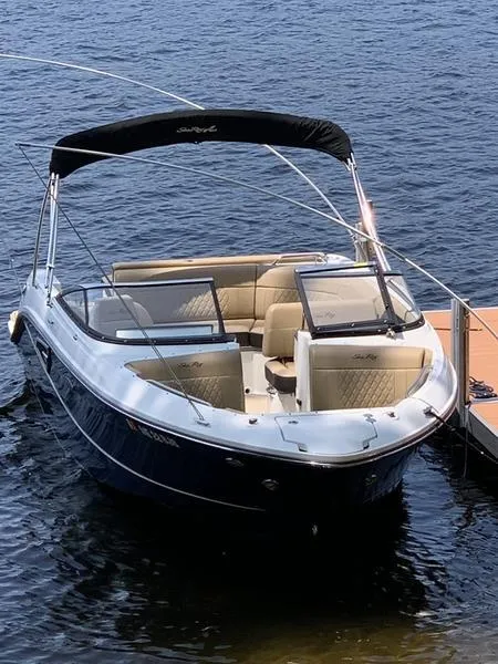 Slide: The Image of 2019 Sea Ray SLX 230 boat docked on calm water. - 10