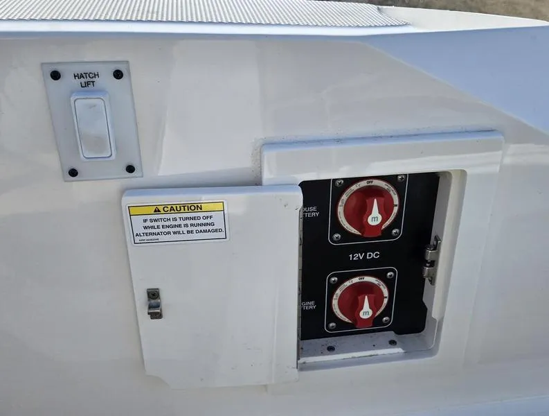 Slide: The Image of 2019 Sea Ray SLX 230 boat battery switches and hatch lift control panel. - 11