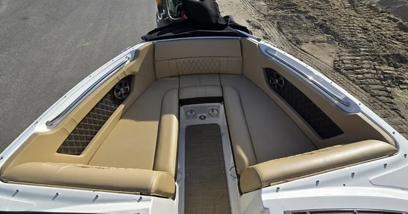 Slide: The Image of 2019 Sea Ray SLX 230 boat interior with tan seating and speaker system. - 2