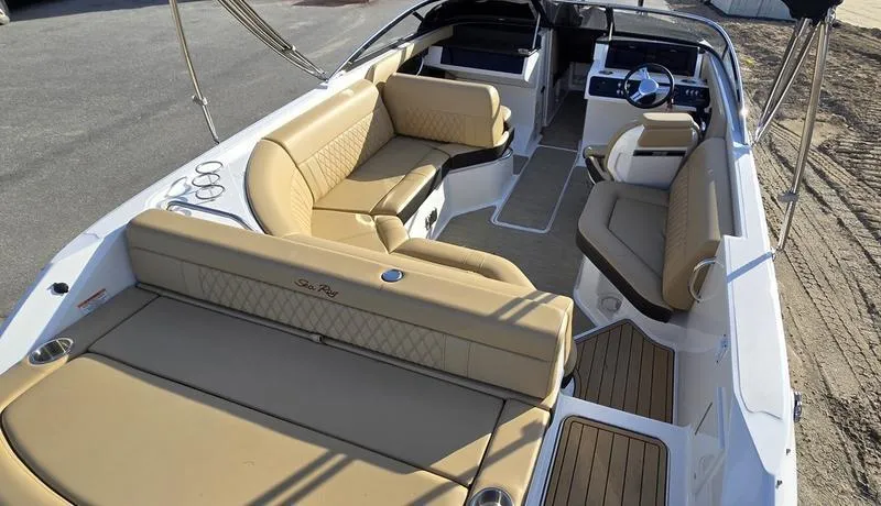 Slide: The Image of 2019 Sea Ray SLX 230 boat interior with tan seating and modern dashboard. - 3