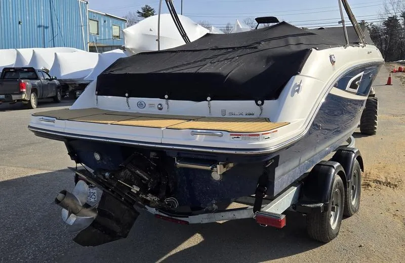 Slide: The Image of 2019 Sea Ray SLX 230 boat on trailer, covered, parked outdoors. - 5