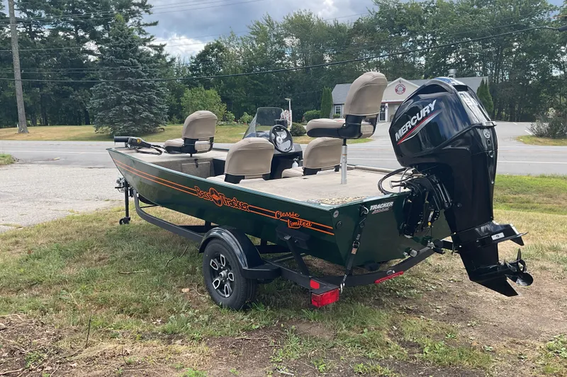 Slide: The Image of 2025 Tracker BT CLASSIC SE boat with Mercury engine on a trailer, parked outdoors. - 10